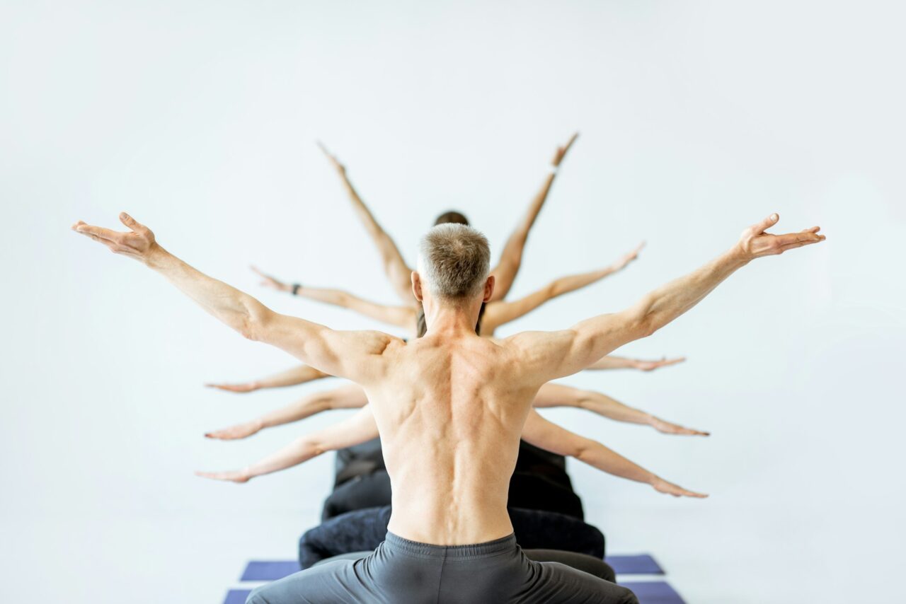 man-in-yoga-pose-with-multiple-arms-on-the-background.jpg